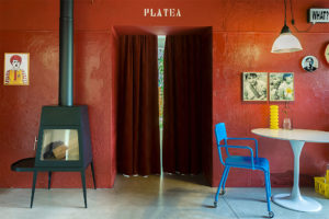 Red wall with the written Platena in the kitchen of Cinema Flora Photographer Maria Teresa Furnari