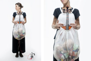 Photo of a woman with objects on her belly the picture is part of Wearable Homes a design project by Denise Bonapace