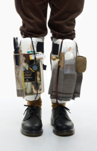Detail of legs with objects tied on them the pictures is parte of Wearable Homes a project by Denise Paca