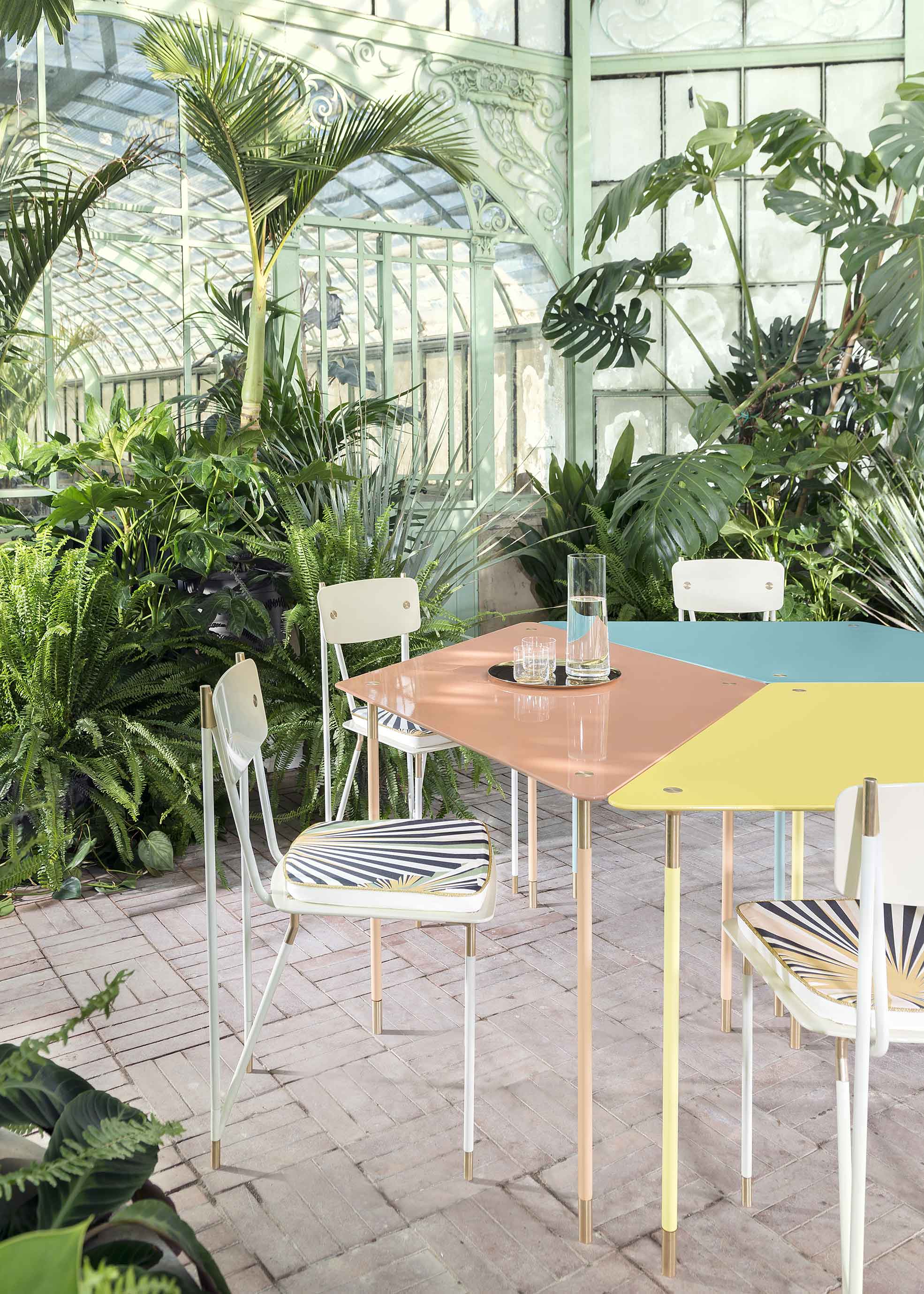 Detail of table and chairs of Aquiloni collection of the designer Derek Castiglioni shot in a greenhouse for AD USA Photographer Maria Teresa Furnari